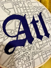 Load image into Gallery viewer, Navy Tattoo Font - 8 inch &quot;ATL&quot; Hand-embroidered Letters over downtown Atlanta Hand-drawn map embroidery hoop
