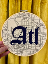 Load image into Gallery viewer, Navy Tattoo Font - 8 inch &quot;ATL&quot; Hand-embroidered Letters over downtown Atlanta Hand-drawn map embroidery hoop
