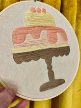 Load image into Gallery viewer, &quot;Sweet Confection&quot; 8-inch Hand-Embroidered Cake Artwork – Pastel Pink, Yellow, and Brown in Wooden Hoop
